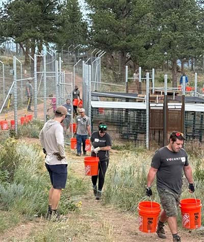 People walking with buckets